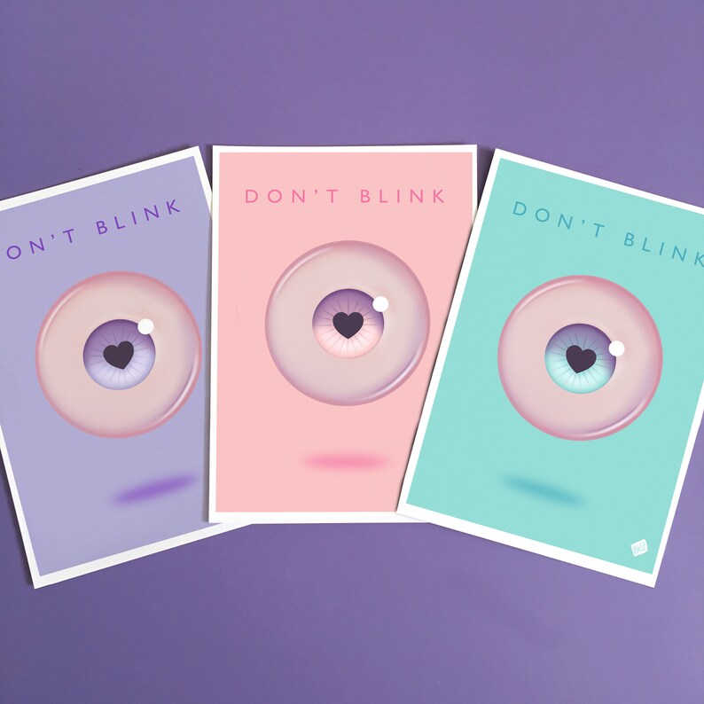 May include: Three pastel colored cards with the text "Don't Blink" and a cartoon eye with a heart in the pupil. The cards are purple, pink, and turquoise.