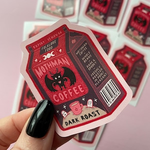 May include: A red and black coffee carton sticker with a mothman illustration and the text "Mothman Coffee" and "Dark Roast".