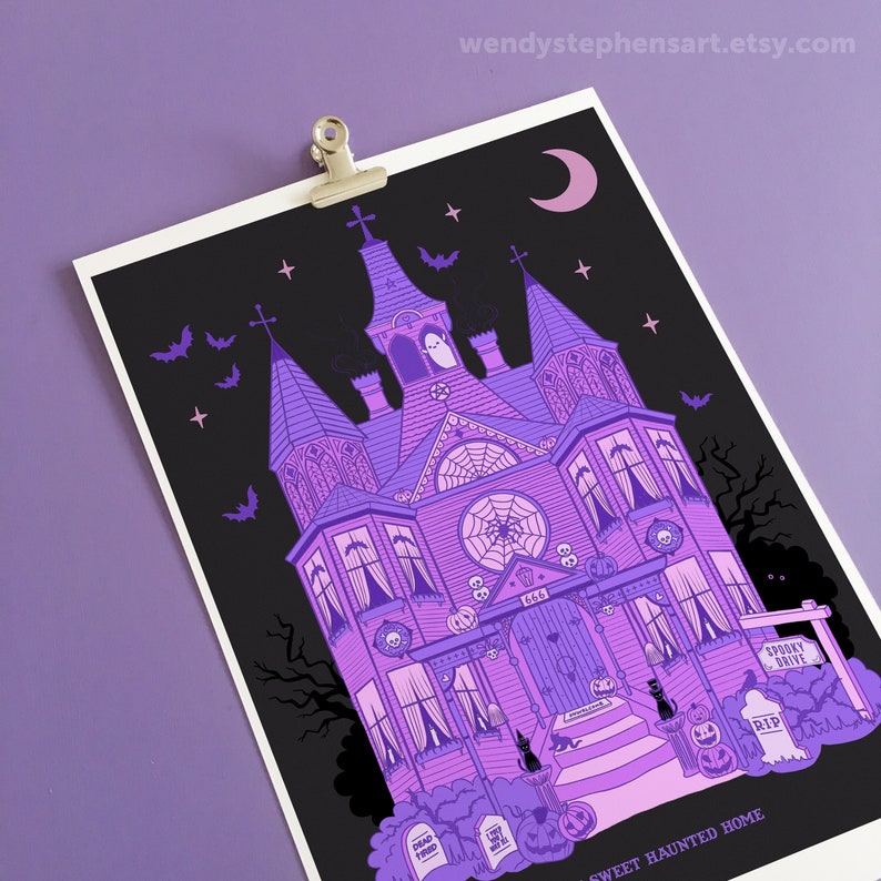 May include: A purple and black illustration of a spooky, gothic-style house with a crescent moon, bats, and stars. The house has a sign that reads "Spooky Drive" and a door with the number 666. The text at the bottom reads "Sweet Haunted Home".