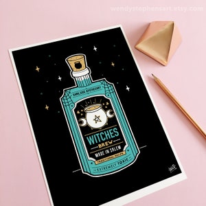 May include: A teal blue bottle with a cork stopper and a label that reads "Dark Side Apothecary Witches Brew Made in Salem Traditional Recipe - Extremely Toxic -" on a black background with gold stars.