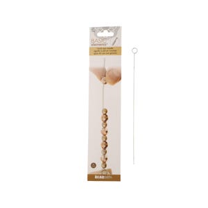 May include: A silver hook eye needle for beading and crocheting. The needle is shown threaded with beads and a length of thread. The packaging includes the text "BASIC elements" and "hook eye needle, aiguille à oeil en crochet, aguja de ojo con gancho".
