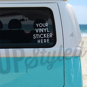 May include: A turquoise blue vintage van with a white roof. The van has a sticker on the back window that says "YOUR VINYL STICKER HERE".