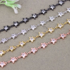 May include: Four chains with star-shaped links, each with a different metal finish: black, silver, gold, and rose gold. Each star has a clear rhinestone in the center.