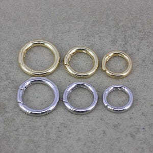 May include: Six metal rings in two different sizes and finishes. Three gold rings and three silver rings.