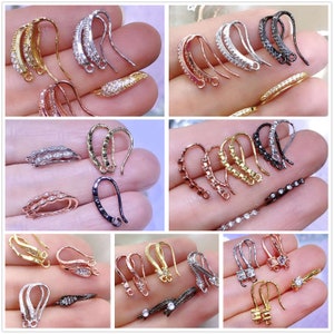 May include: Assortment of earring hooks with various finishes, including gold, silver, rose gold, and black. Each hook is adorned with clear cubic zirconia stones.