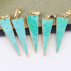 May include: Six turquoise triangle shaped pendants with gold-toned metal settings. The pendants are all different sizes and shapes.