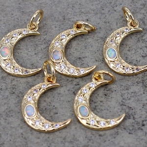 May include: Five gold crescent moon charms with opal stones and clear rhinestones. Each charm has a loop for attaching to a necklace or bracelet.