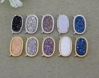 May include: Nine oval-shaped agate gemstone pendants with gold and silver settings. The gemstones are in various colors, including white, gray, blue, pink, and purple.
