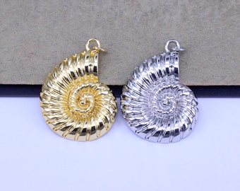 May include: Two gold and silver nautilus shell pendants. The pendants are detailed with a spiral design and have a loop at the top for attaching a chain.