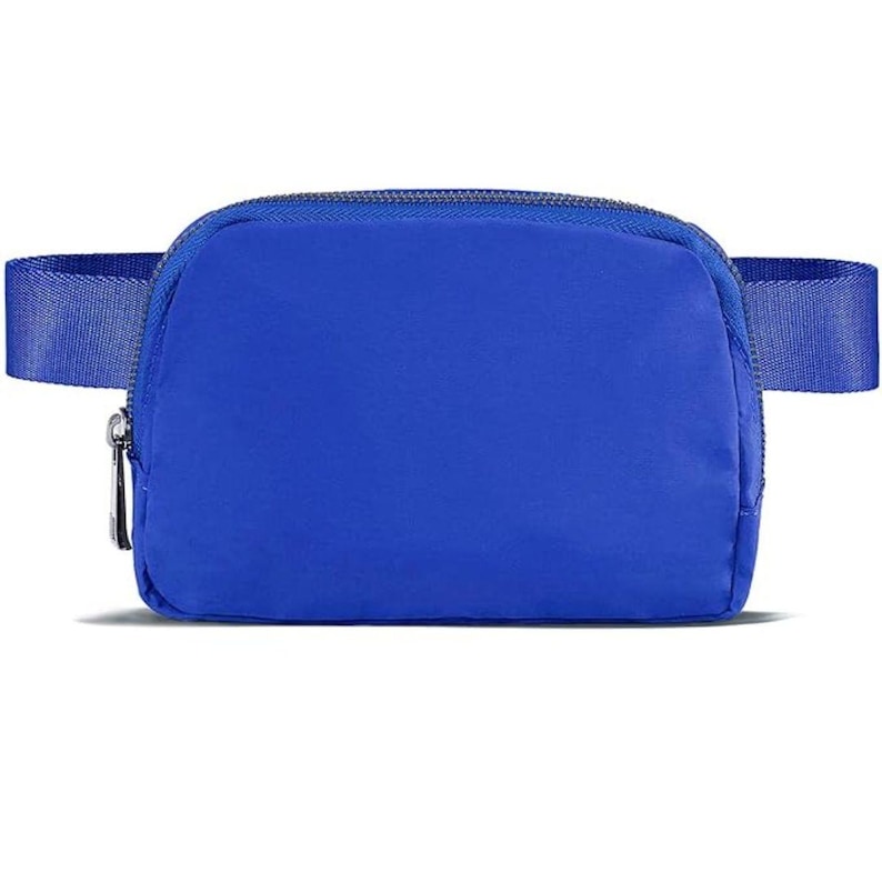 May include: A vibrant blue fanny pack with a zippered main compartment and an adjustable strap. The bag is made of a smooth, durable material and features a silver zipper pull. The design is simple and modern, suitable for various activities.