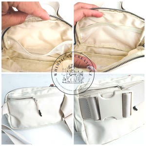 May include: Cream-colored fanny pack with multiple compartments, including zippered and mesh pockets. The bag features a white adjustable strap with a plastic buckle. The interior lining is a light beige color. The bag is designed for carrying essentials.