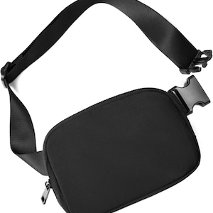 May include: A black fanny pack with a zippered main compartment and adjustable strap. The strap features a plastic buckle for secure closure. The bag is made of a smooth, matte material and is designed for hands-free carrying.