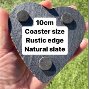 May include: A heart-shaped slate coaster with a rustic edge. The coaster is 10cm in diameter and has a natural slate finish. The coaster has three felt pads on the bottom to protect surfaces.