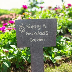 May include: A black slate garden marker with the text "Nanny & Grandad's Garden" and a small ladybug illustration.