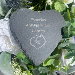 May include: A gray heart-shaped slate stone with the inscription "Maurice always in our hearts" and a stylized cat silhouette.