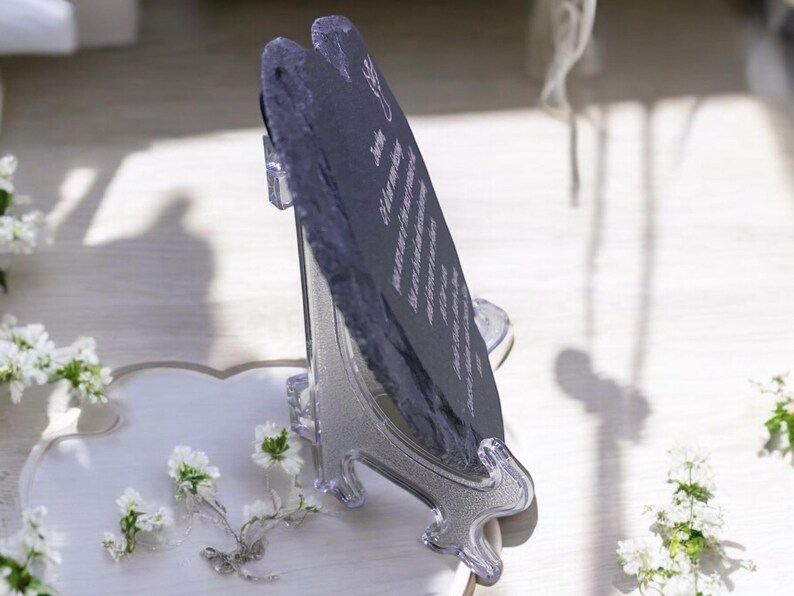 May include: A black slate heart-shaped plaque with a white inscription on a clear plastic stand. The inscription reads "You are my everything, my forever, my always".