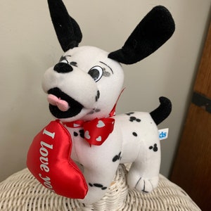 May include: A white and black dalmatian plush dog holding a red heart that says "I love you".