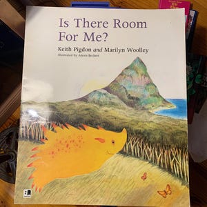 May include: A children's book titled "Is There Room For Me?" features a colorful illustration of a yellow creature with orange spikes, a mountain, and butterflies. The book cover has the author's names and the illustrator's name.