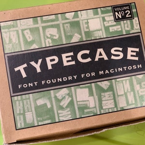 May include: A brown cardboard box with a green and white pattern. The box has the text "TYPECASE FONT FOUNDRY FOR MACINTOSH" and "VOLUME No 2" printed on it.