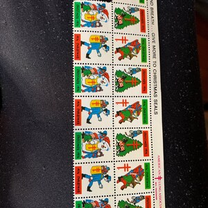 May include: A sheet of 10 Christmas Seals featuring a red cross and various holiday scenes. The text "LIFE AND BREATH... GIVE MORE TO CHRISTMAS SEALS" and "AMERICAN LUNG ASSOCIATION" are printed on the sheet.