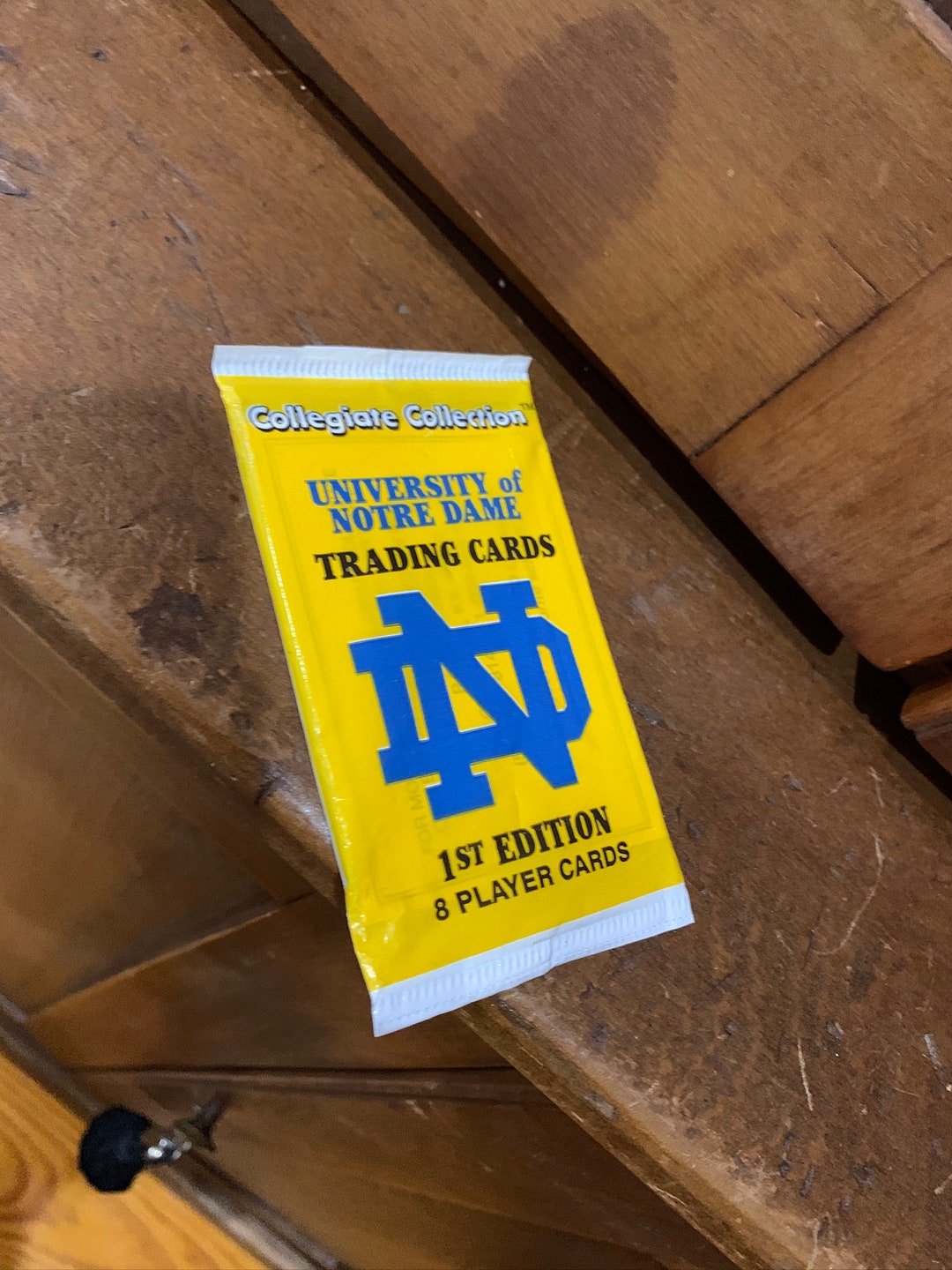 first edition notre dame trading cards Hunchback of vintage '90s card pack with a yellow border against a blue background 1990 Notre Dame Fighting Irish