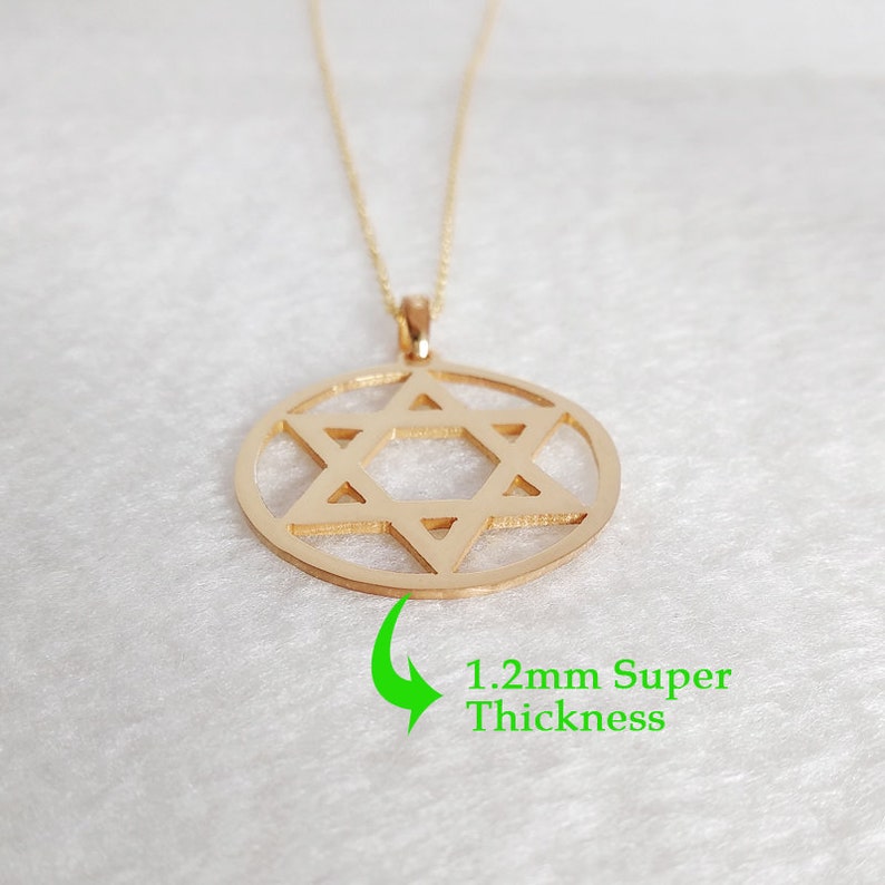 May include: A gold chain necklace with a pendant featuring a Star of David design. The pendant is 1.2mm thick.