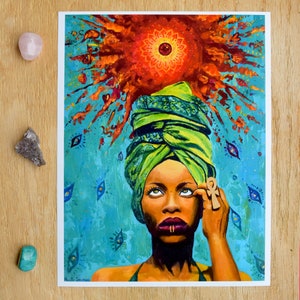 May include: A colourful painting of a woman wearing a green head wrap and holding a golden ankh symbol. The woman is looking up at a red and orange sun with a mandala design. The background is blue with many eyes.