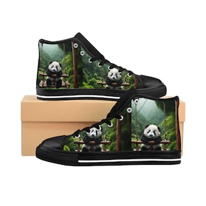May include: Black high-top trainers with a panda bear on a swing set design. The panda is set against a backdrop of a lush green forest. The shoes have black laces, a black toe cap, and a white stripe along the sole.