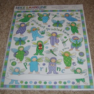 May include: A sheet of scrapbook stickers featuring whimsical fairy illustrations in various colors. The stickers include fairies, butterflies, and dragonflies, with the words "pixie dust sprinkled here" and "prince".