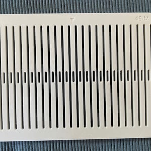 May include: White plastic vent cover with a grid pattern and the text "49/M" printed on the top right corner.