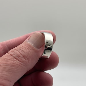May include: A silver band ring with a smooth, polished finish.