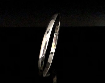 May include: A silver bangle bracelet with a smooth, polished finish.