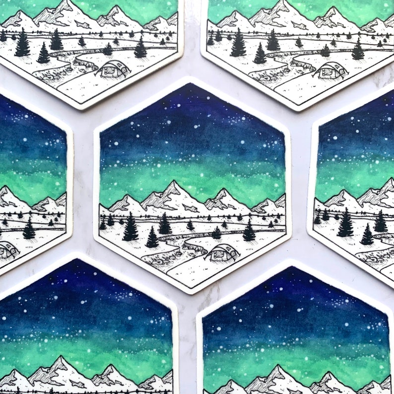 May include: Six hexagonal stickers with a watercolor background of a starry night sky with a green aurora borealis. Each sticker features a black and white illustration of a mountain range, a river, and a tent.