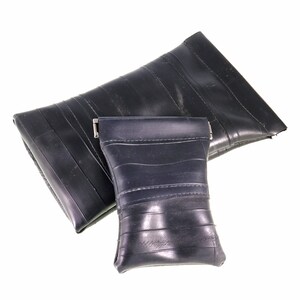 May include: Two black zippered pouches made from recycled inner tubes. The pouches are different sizes and have a textured surface.