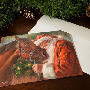 May include: A Christmas card featuring a painting of Santa Claus with a brown horse. Santa is wearing a red suit and a white beard. The horse has a brown halter and is wearing a green wreath around its neck. The card is signed "Celeste Sweeney".