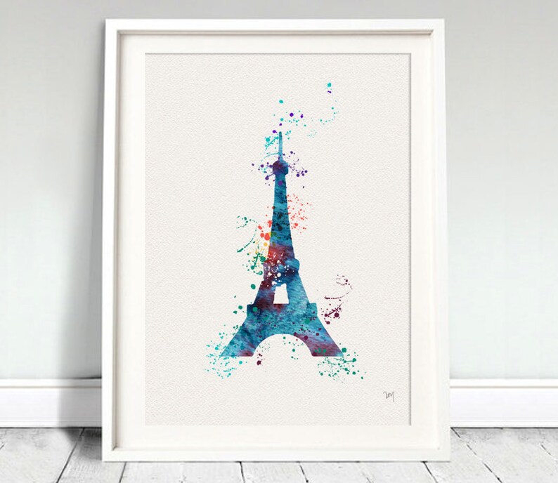 Puede incluir: Una pintura de acuarela de la Torre Eiffel en tonos azules, morados y verdes. La torre est&aacute; rodeada de salpicaduras de acuarela de colores.