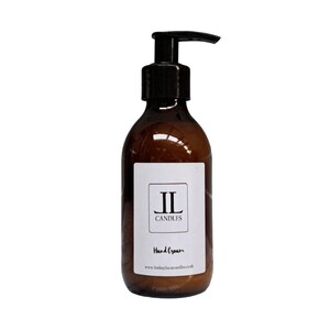 May include: A brown glass bottle with a black pump dispenser. The bottle has a white label with the text "IL CANDLES" and "Hand Cream". The website address www.lindsaylucascandles.co.uk is printed at the bottom of the label.