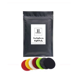 May include: A black pouch with a white label that reads "JL Candles Car Freshener Refill Pads www.lindsaylauracandles.co.uk". The pouch contains six round, felt car air freshener refill pads in red, yellow, white, green, grey, and black.