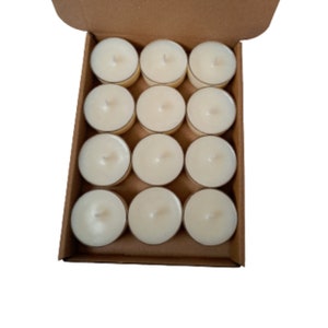 May include: A box of 12 white unscented tea light candles. The candles are arranged in a 4x3 grid in a brown cardboard box.