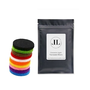 May include: A pack of 10 colorful felt diffuser discs for essential oils. The discs are stacked in a pile and are labeled "Cinnamon Apple Vacuum Discs" and "www.lindsaylucascandles.co.uk".