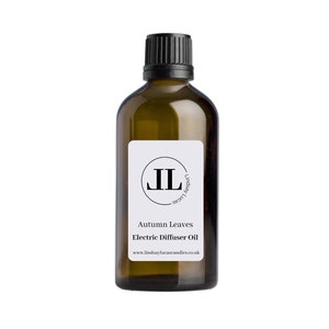 May include: A brown glass bottle with a black cap and a white label. The label has a black circle with the letters "JL" inside. The text on the label reads "Autumn Leaves Electric Diffuser Oil" and "www.lindsaylucascandles.co.uk".