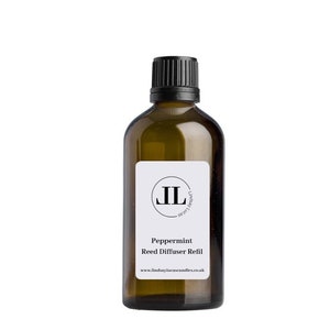 May include: A brown glass bottle with a black lid and a white label. The label has a black circle with the letters "JL" inside. The text on the label reads "Peppermint Reed Diffuser Refill" and "www.lindsaylucascandles.co.uk".