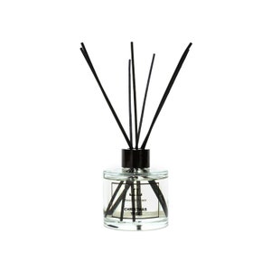 May include: A clear glass bottle with black reeds and a black cap. The bottle contains a clear liquid and has a label that reads "Reed Diffuser Christmas Tree".