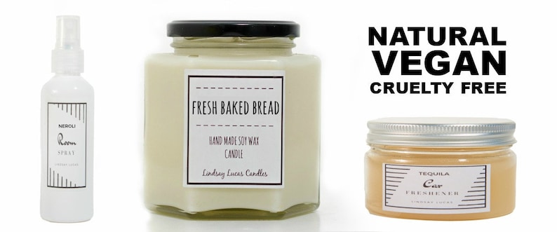May include: Three glass jars with labels. The first jar is a white room spray with a black label that says "Neroli Room Spray". The second jar is a white candle with a black label that says "Fresh Baked Bread Hand Made Soy Wax Candle Lindsay Lucas Candles". The third jar is a clear amber car freshener with a silver lid and a black label that says "Tequila Car Freshener Lindsay Lucas Candles". The text "Natural Vegan Cruelty Free" is written in black letters on a white background.