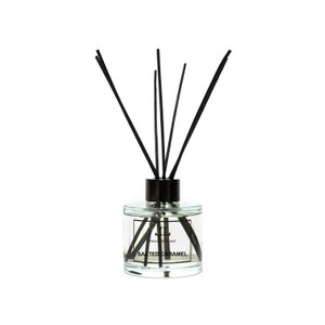 May include: A clear glass bottle diffuser with black reeds and a black cap. The bottle has a label that reads "Reed Diffuser Salted Caramel".