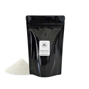 May include: A black resealable pouch filled with white carpet freshener powder. The pouch has a label that reads "Patchouli & Leather Carpet Freshener" and a logo with the initials "JL".