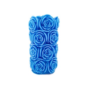 May include: A blue candle shaped like a bouquet of roses. The candle is made of wax and has a smooth, polished finish.