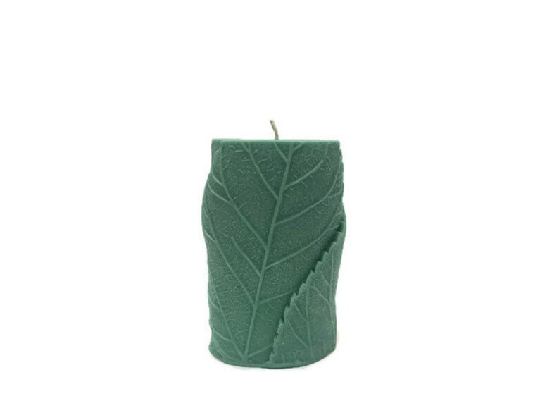 May include: A green leaf-shaped candle with a textured surface.