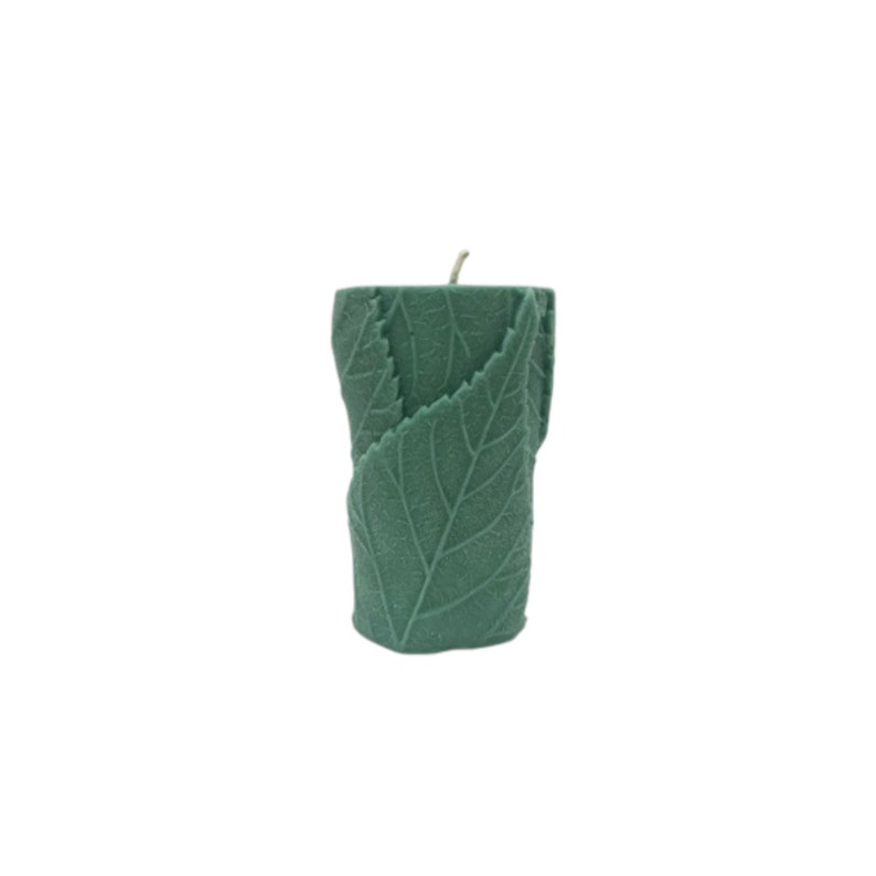 May include: A green pillar candle with a leaf design. The candle is made of soy wax and has a natural scent.