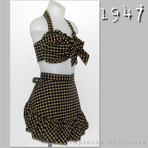 May include: A black and yellow checked two-piece swimsuit with a halter top and a skirt. The top has a bow at the front and the skirt has a ruffle at the bottom. The text "1947" is visible in the image.